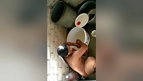 This nude video shows a brunette naked outdoors in bath