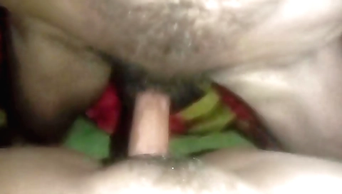 A hairy indian girl with a cute face and long hair on a sofa