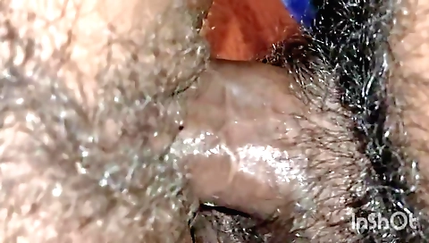 Indian babe in a tight red dress fucks her hairy bush