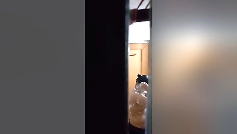 Barely nude brunette in white and black shorts in bathroom