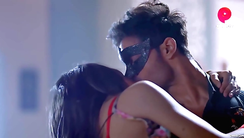 Buxom brunette with long hair in front of a computer