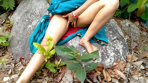 Indian girl with a hairy bush is outdoors and playing with a rock